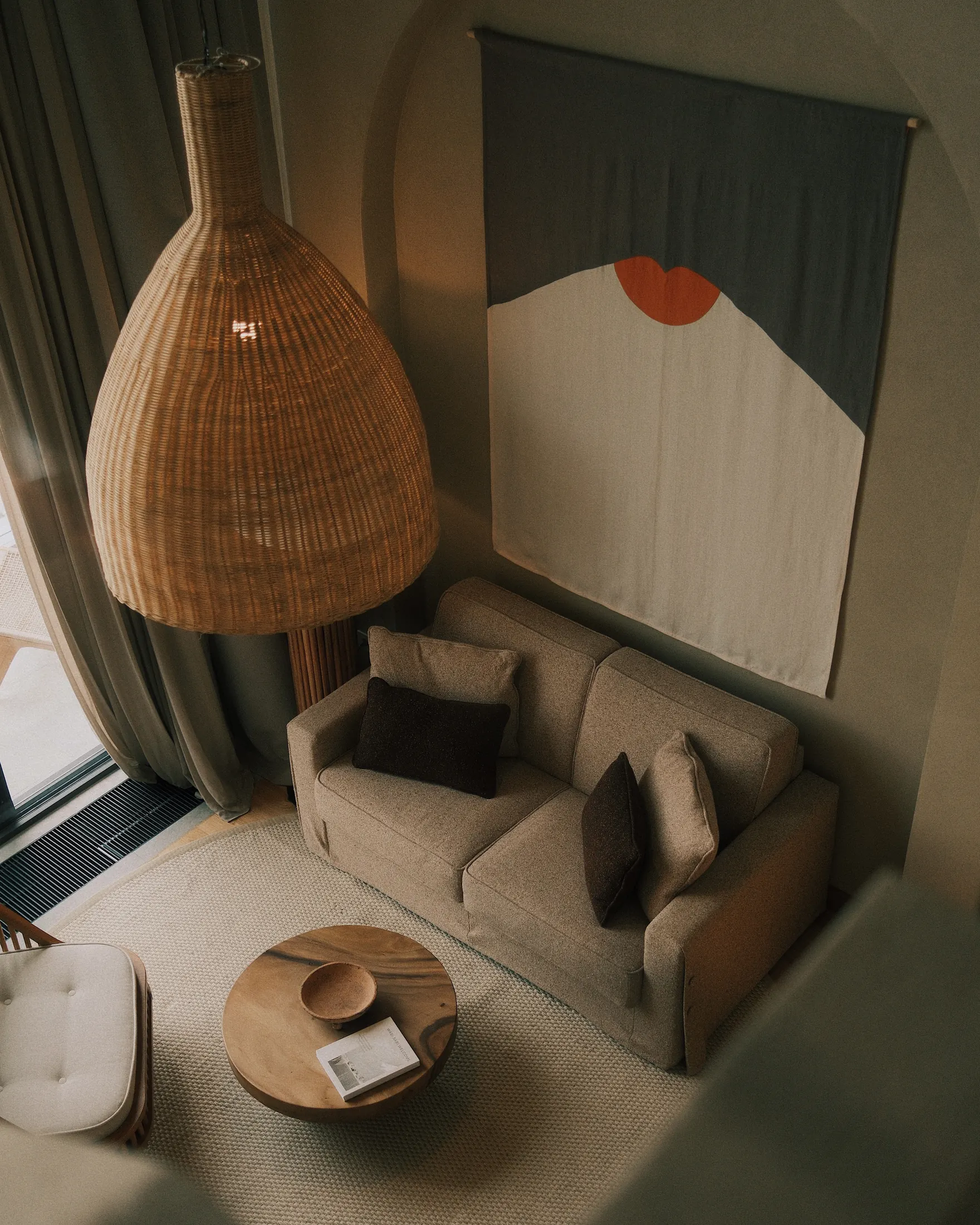 Living room beneath a woven pendant lamp