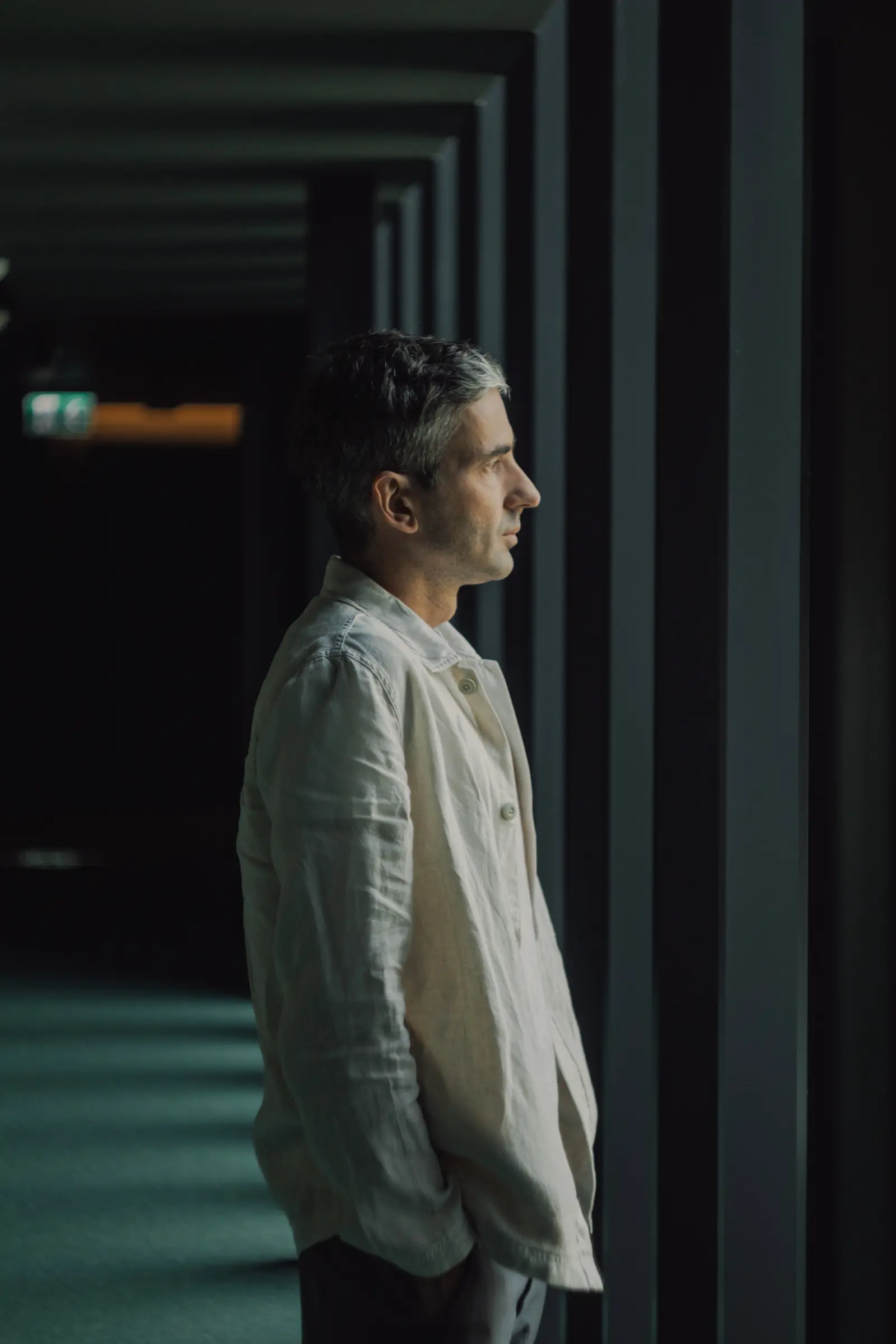 Profile portrait in a dark corridor