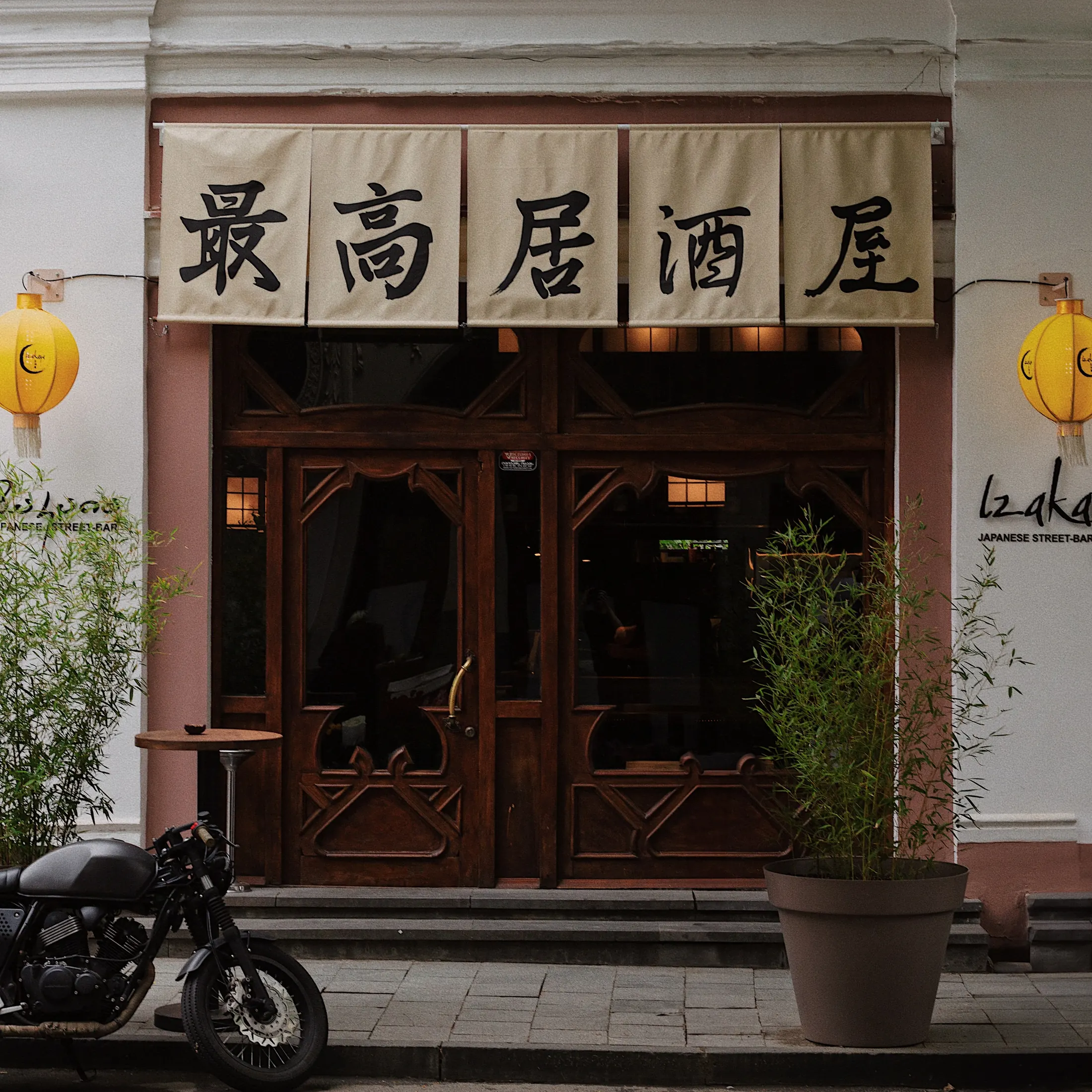 Izakaya entrance, lanterns lit